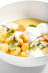 Wild mushroom cream soup with cheese profiteroles