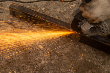 Sparks from sawing metal at a construction site