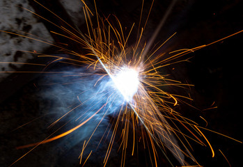 sparks from metal welding at a construction site