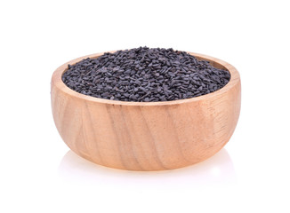 Black sesame in a wooden cup isolated on white background