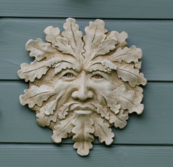 Stylized pottery face of the 'Green Man' as a wall plaque