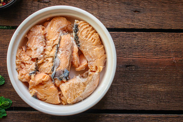 canned salmon, fish preserves (seafood in a tin can) menu concept background. top view. copy space...