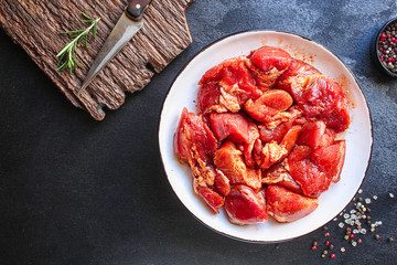 raw meat pork or beef in a plate on the table (preparing healthy food, marinade and spices paprika) menu concept background. top view. copy space for text