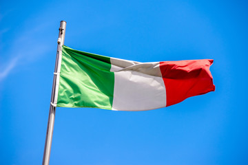 Italian flag fluttering on a metal flagpole