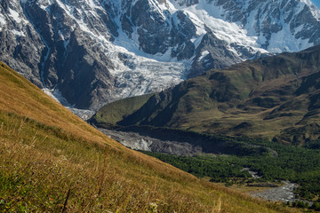 Mountain walls with glacier and its tongue Svaneti Georgia