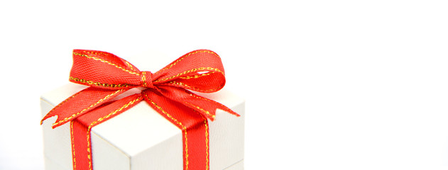 White gift box with red ribbons isolated on white background