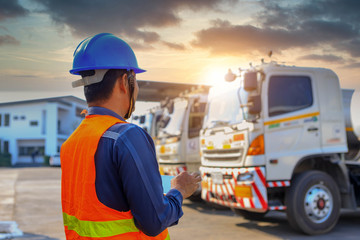 Truck drivers hand holding tablet checking the product list,Driver writing electronic log...