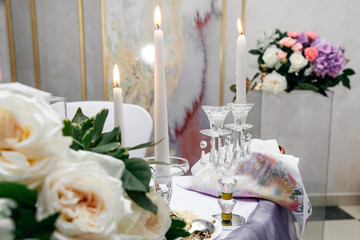  burning white candles on a light background