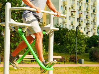 Fototapeta premium Man doing legs exercises in outdoor gym