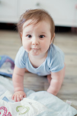 Fototapeta premium Cute caucasian baby in a blue cloth
