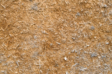 Old crumbling particle board on wall closeup