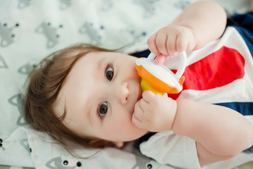 Little boy eat fruits from baby's nibbler