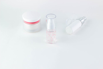 Face care cosmetics. Cosmetic bottles with serum, gel, face cream on a white background.