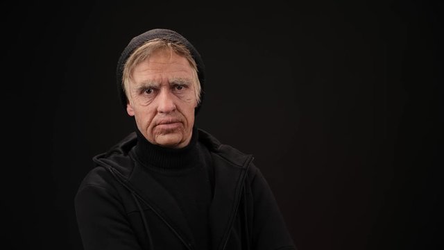 plastic makeup. makeup for cinema. old man on a black background