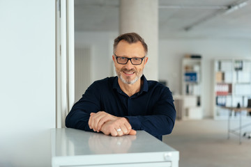 Fototapeta premium Happy relaxed businessman with a friendly grin
