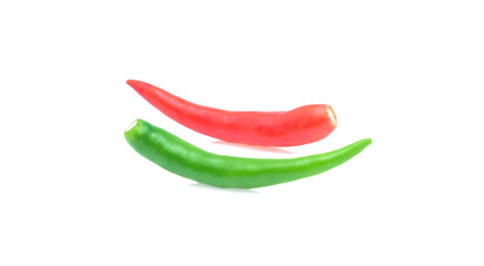 Fresh red and green hot chili peppers on white background