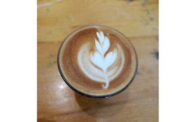 Obraz na płótnie Canvas Coffee latte art on wood table