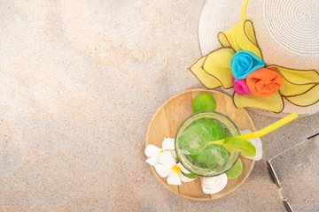 Fototapeta na wymiar Lemon italian soda with beach accessories on beach.