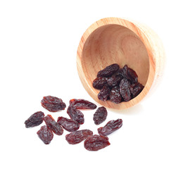 Fototapeta premium Dried raisins in wooden cup on white background.