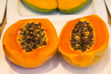 sliced papaya fruit on a light background