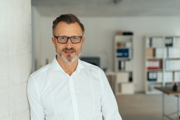 Thoughtful calm businessman staring at the camera