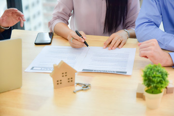 Couple sing contract to by home