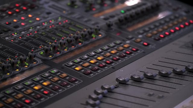 Faders And Lights Starts To Move In Vegas Mode On The Sound Board During A Music Festival In Ontario, Canada - Closeup Shot