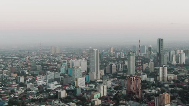 Aerial Drone shot of Cubao in Quezon City, Manila, Philippines while sunrise
