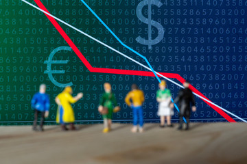 Figurines right before a negative stock exchange chart 