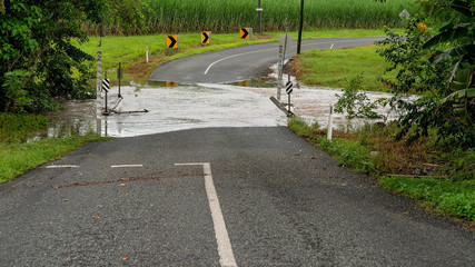Heavy Tropical Rainfall Causes Flooding Over Creek Road