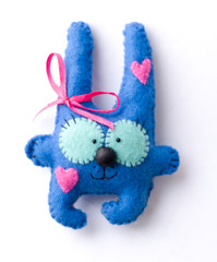 Toys made of felt on a white background, colored hare