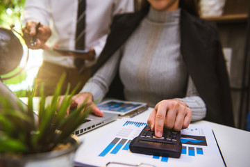 Business People Talking Discussing with financial document data charts and graphs Team business meeting with smart phone and laptop and digital tablet computer