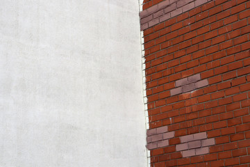 Background of two different walls - white concrete and red brick