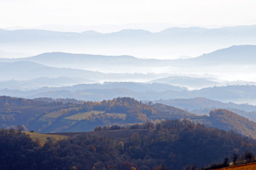  Distant hills in the haze. Beautiful mountain scenery. Mystical rural scenes. Scattered houses of mountain villages. Beautiful nature background.