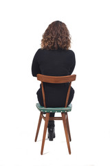 rear view of a woman sitting on chair on white background, arms crossed
