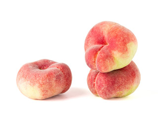Fresh flat peach isolated on white background.