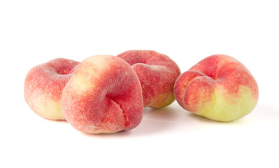 Fresh flat peach isolated on white background.
