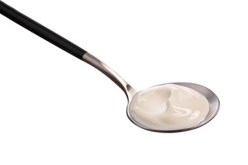 Spoon with tasty yogurt on white background