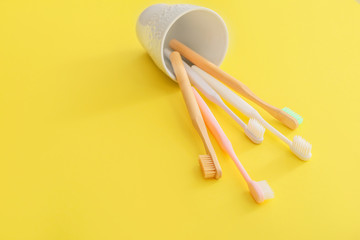 Holder with tooth brushes on color background