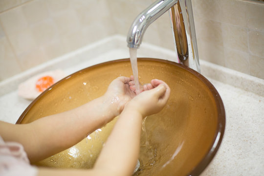 Pretty Little Asian Kazakh Girl In Mask Washing Her Hands. Person, Man, Woman In Mask.