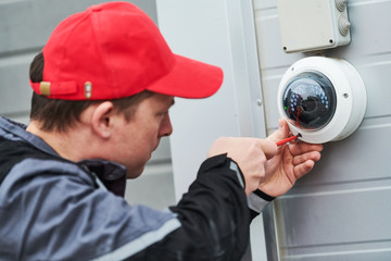 video surveillance service. Technician installing camera