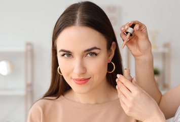 Professional makeup artist working with young woman in salon, closeup
