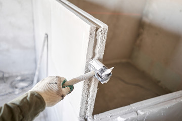 Obraz premium Tools on Gypsum plate. Construction of internal walls in the apartment using a plaster concrete plate with groove ridge.