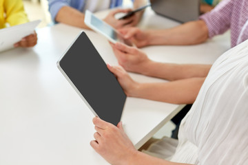 education, technology and people concept - group of high school students or classmates with tablet pc computers at table