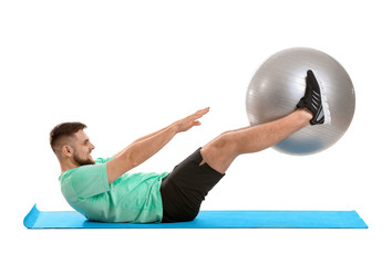 Sporty young man training on white background