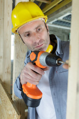 man drilling wood with battery power