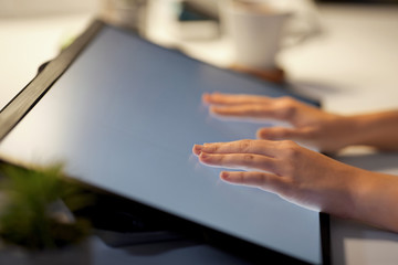 technology and people concept - hands on led light tablet or touch screen at night office