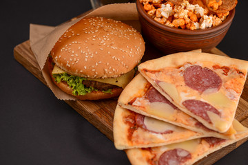 Tasty and appetizing hamburger on a darkly green background