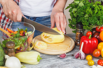 Woman cooks at the kitchen, body part