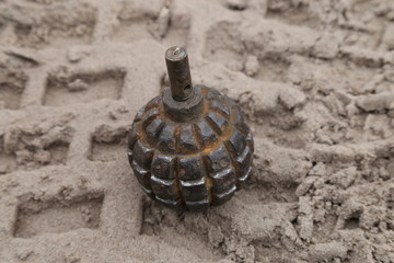 World War I hand grenade in the sand